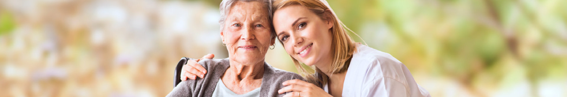 caregiver and old woman showing their genuine smile